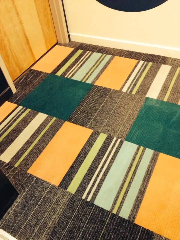 A colorful striped floor with a door in the background