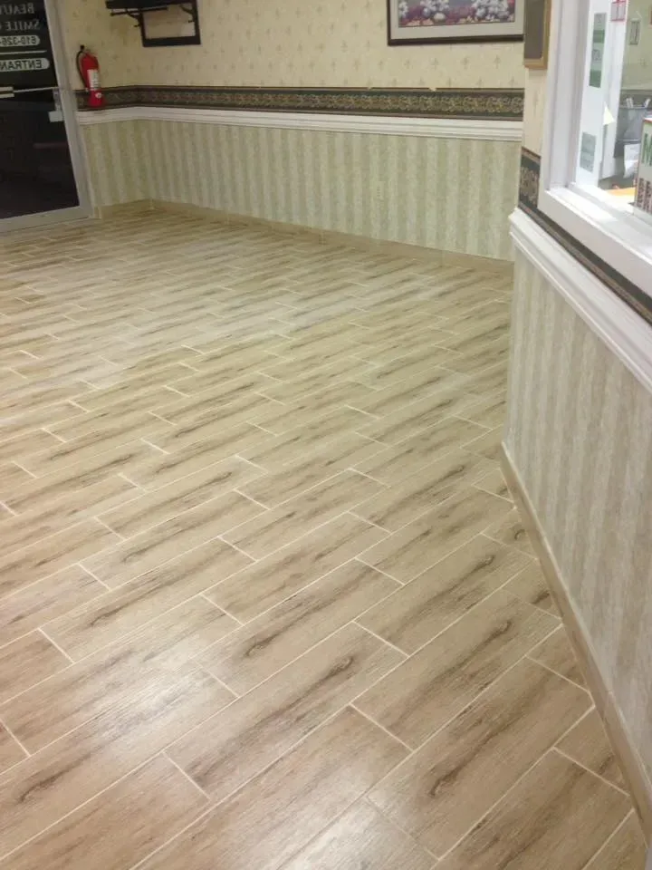 A room with a wooden floor and a striped wall.