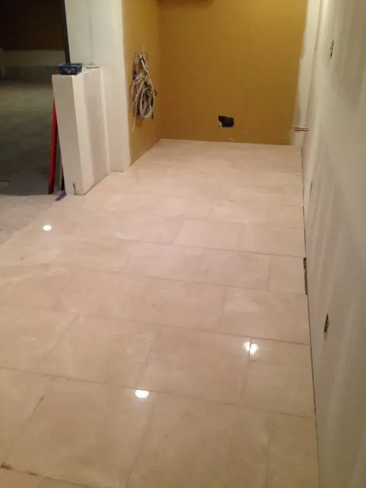 A room with a tiled floor and a yellow wall.