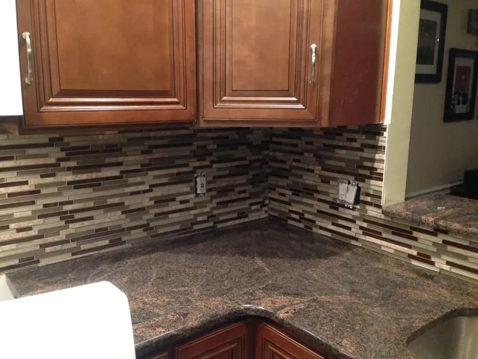 A kitchen with wooden cabinets and a granite counter top.