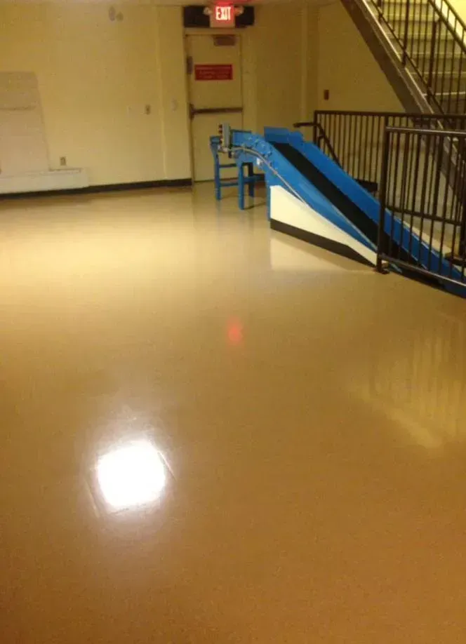 An empty hallway with stairs and a ramp