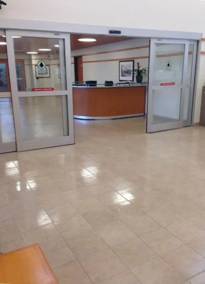 A lobby with sliding glass doors and a counter