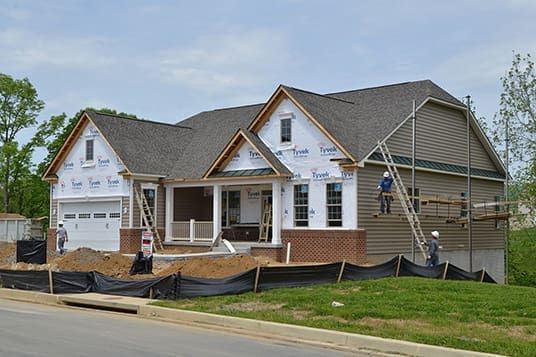 A large house is being built in a residential area.