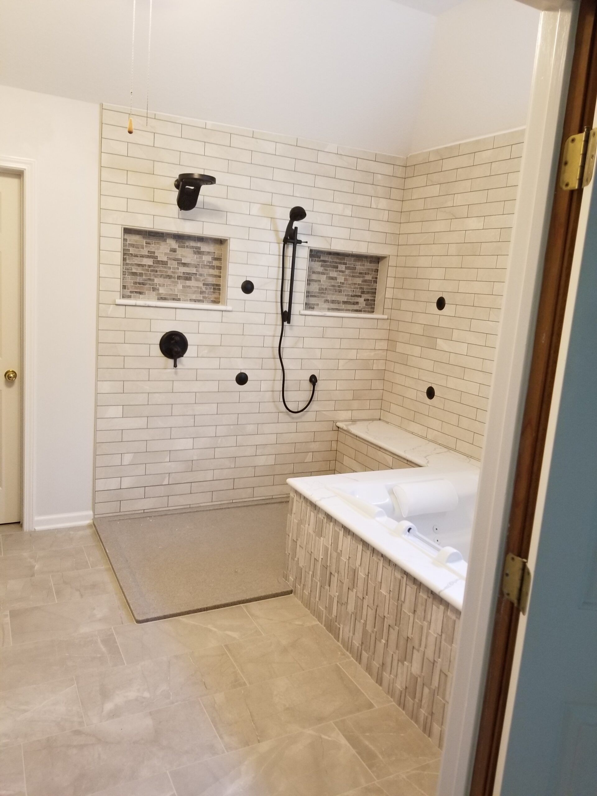 A bathroom with a walk in shower and a bathtub