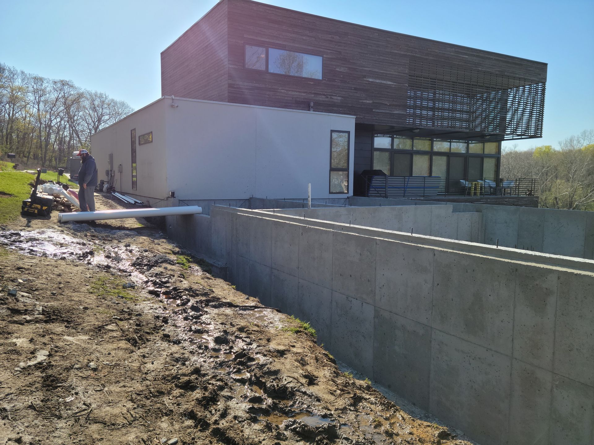 A large building is being built in the middle of a dirt field.