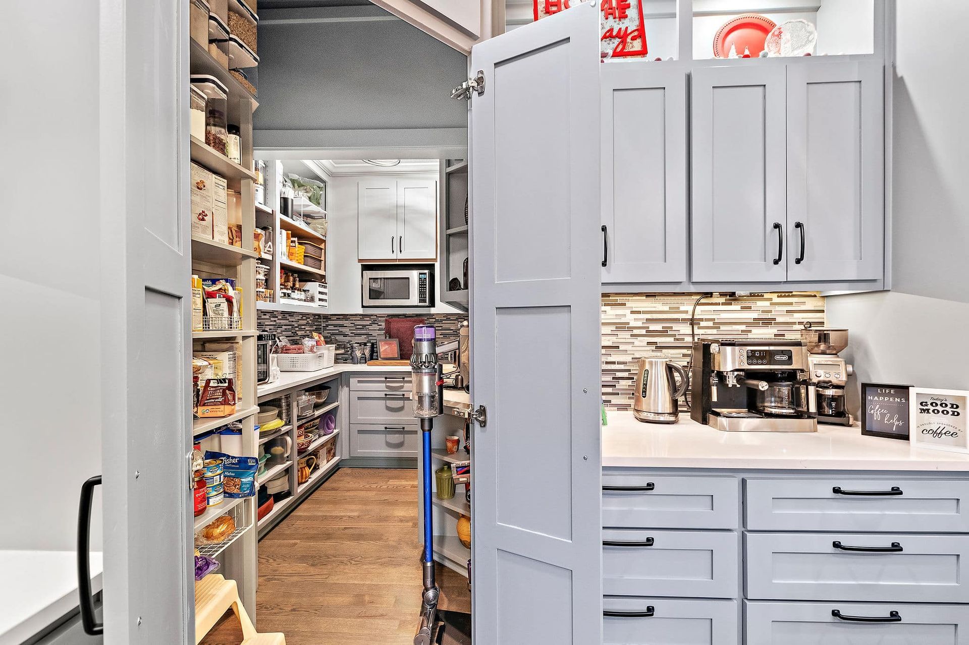 A kitchen with a pantry and a refrigerator.