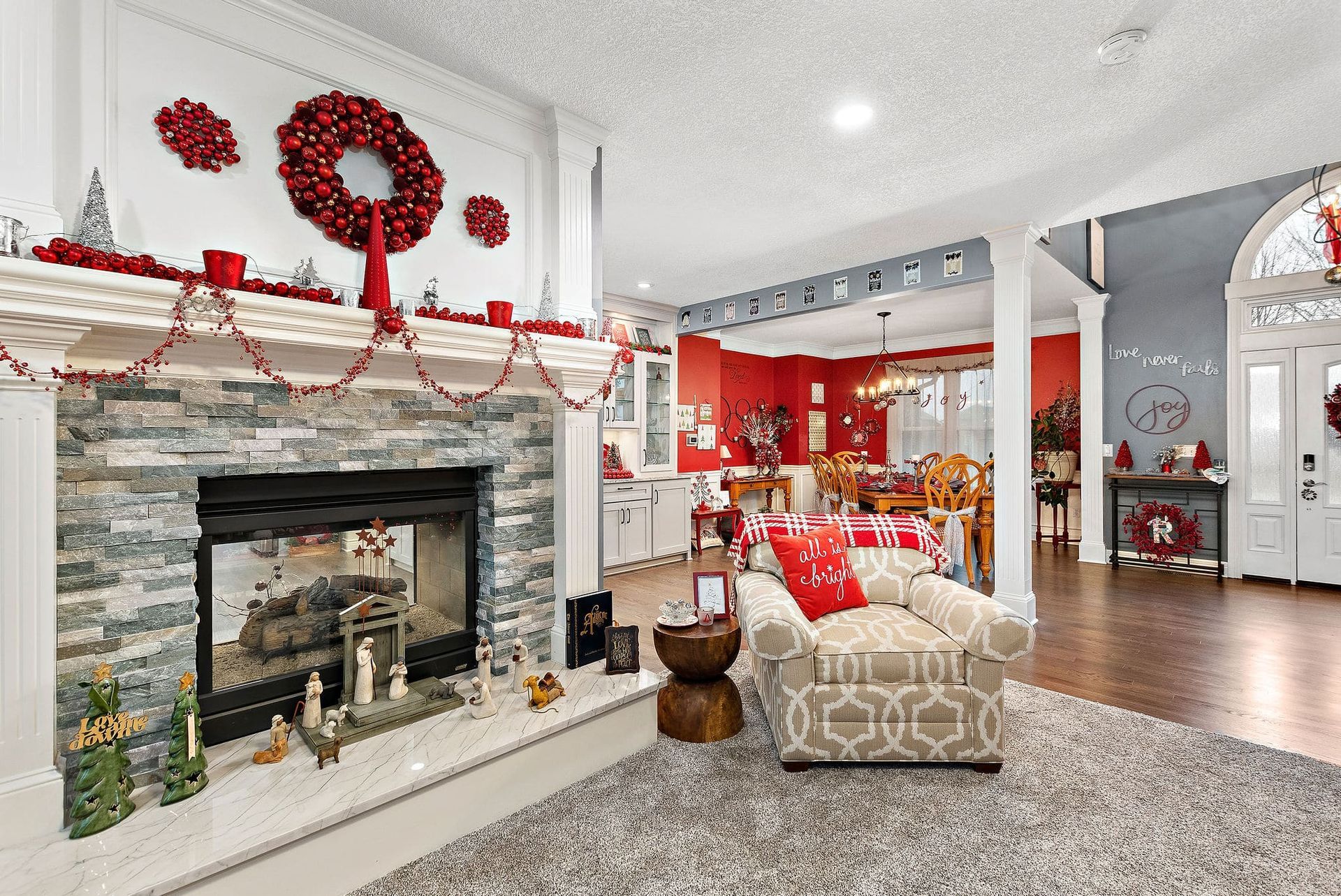 A living room with a fireplace decorated for christmas