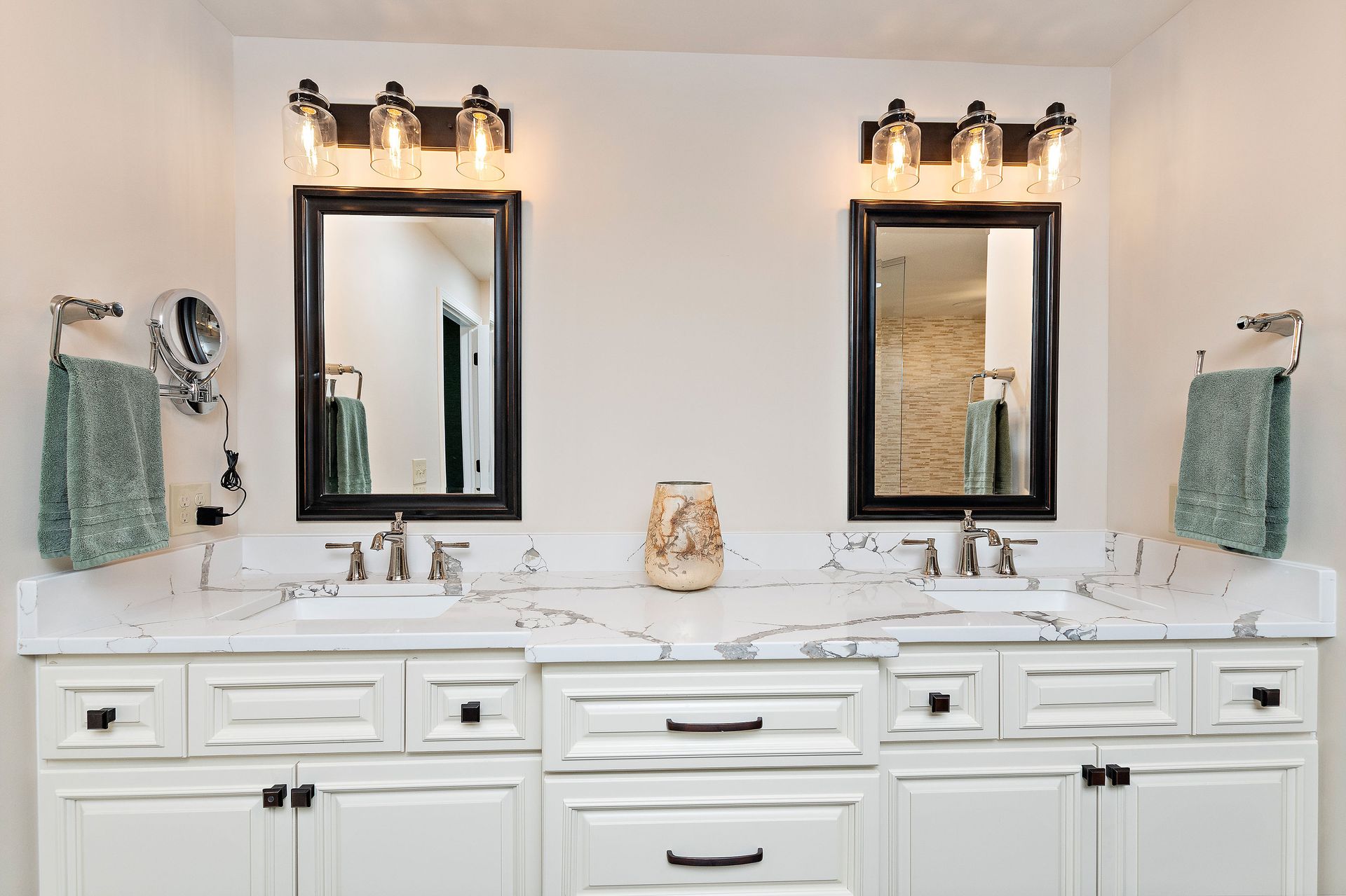 A bathroom with two sinks and two mirrors.