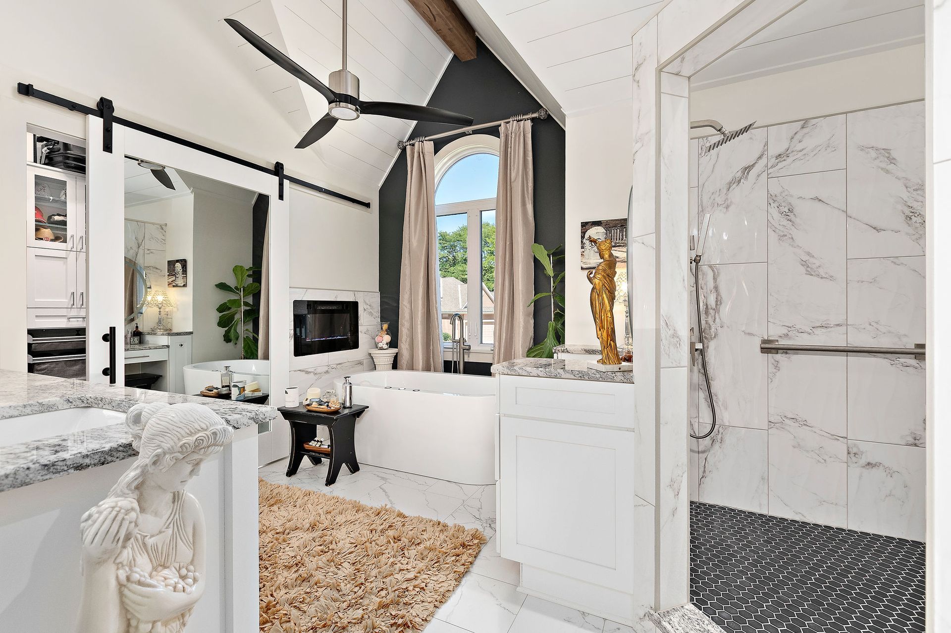 A bathroom with a bathtub and a ceiling fan.