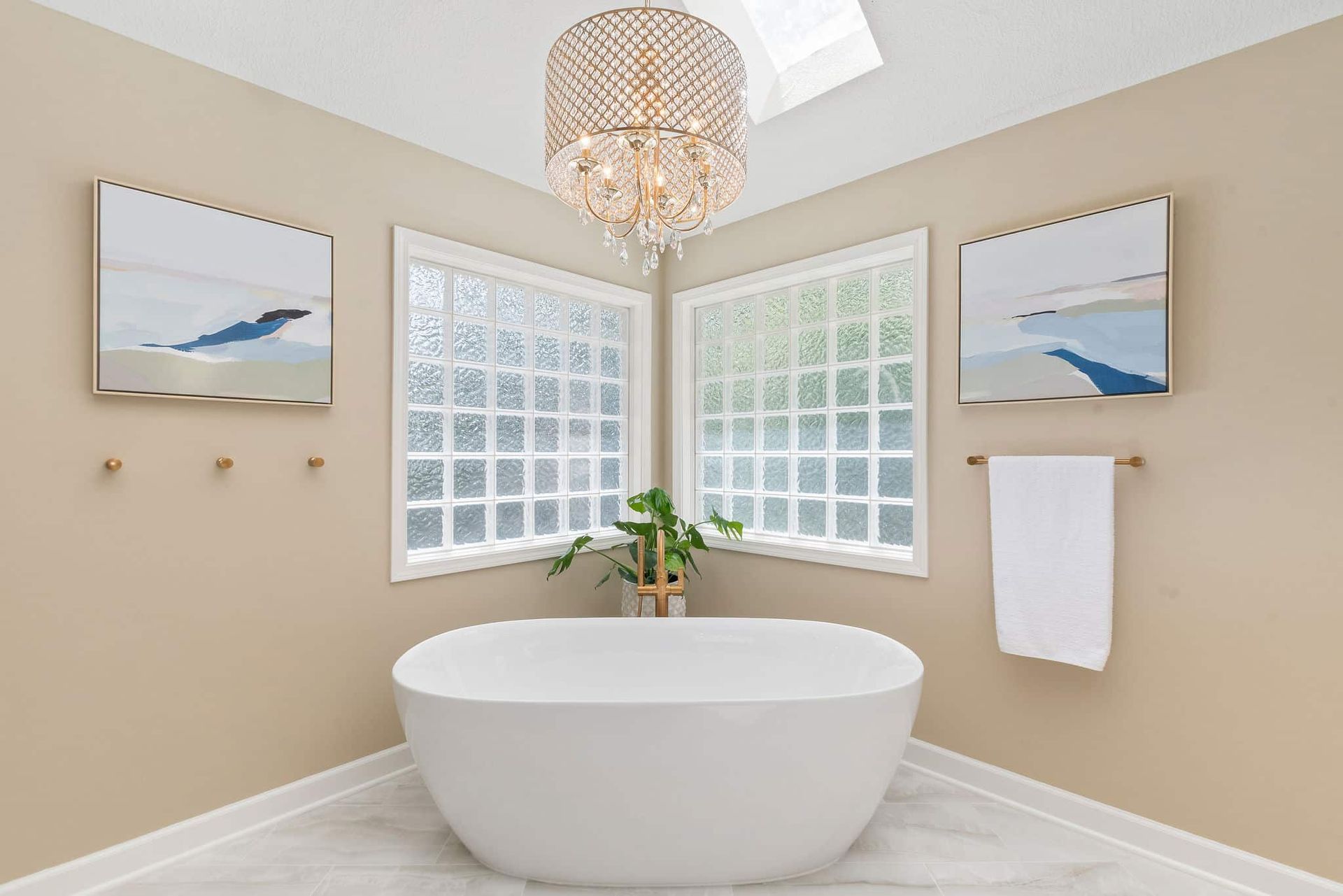 A bathroom with a bathtub and a chandelier hanging from the ceiling.