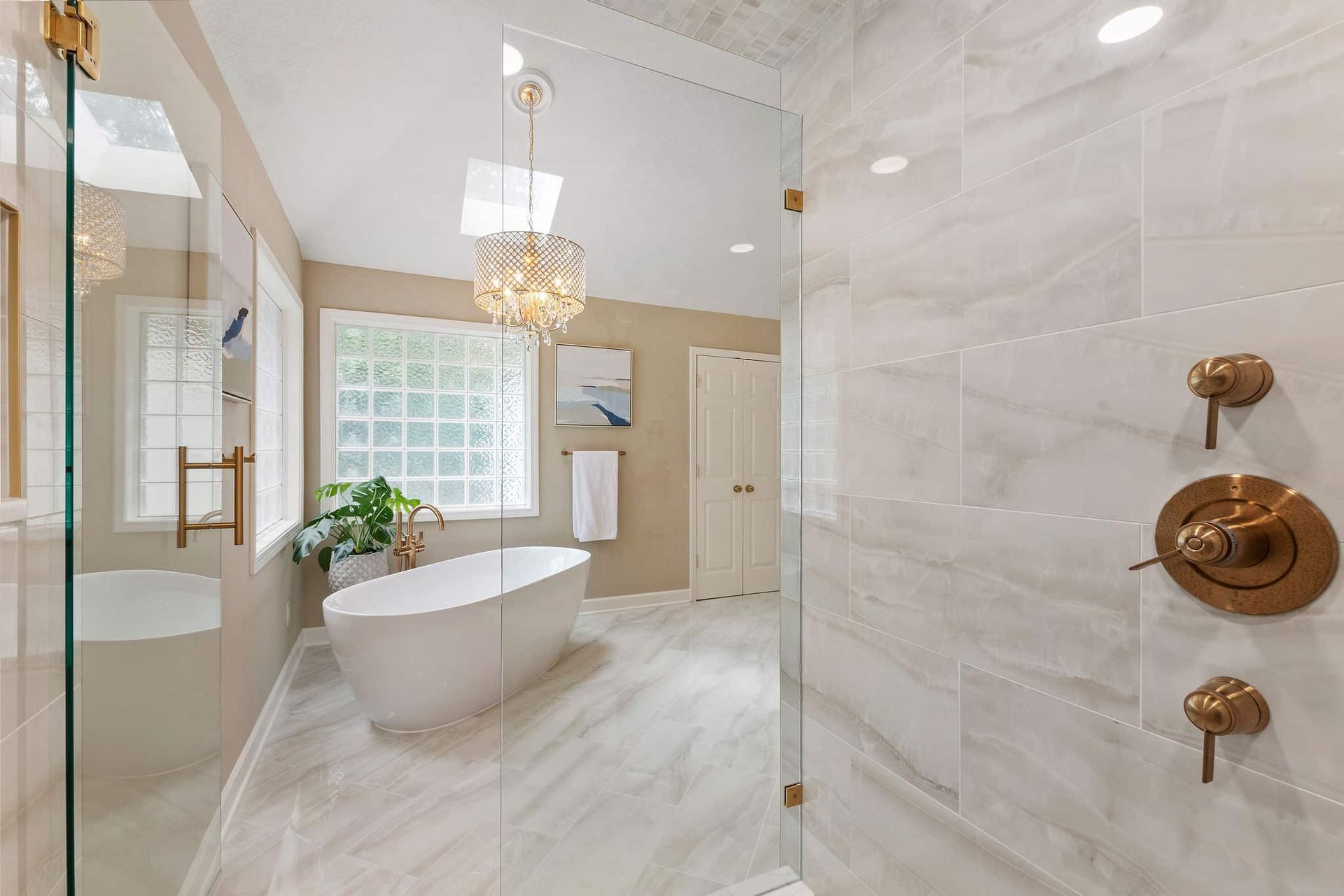 A bathroom with a bathtub and a walk in shower.