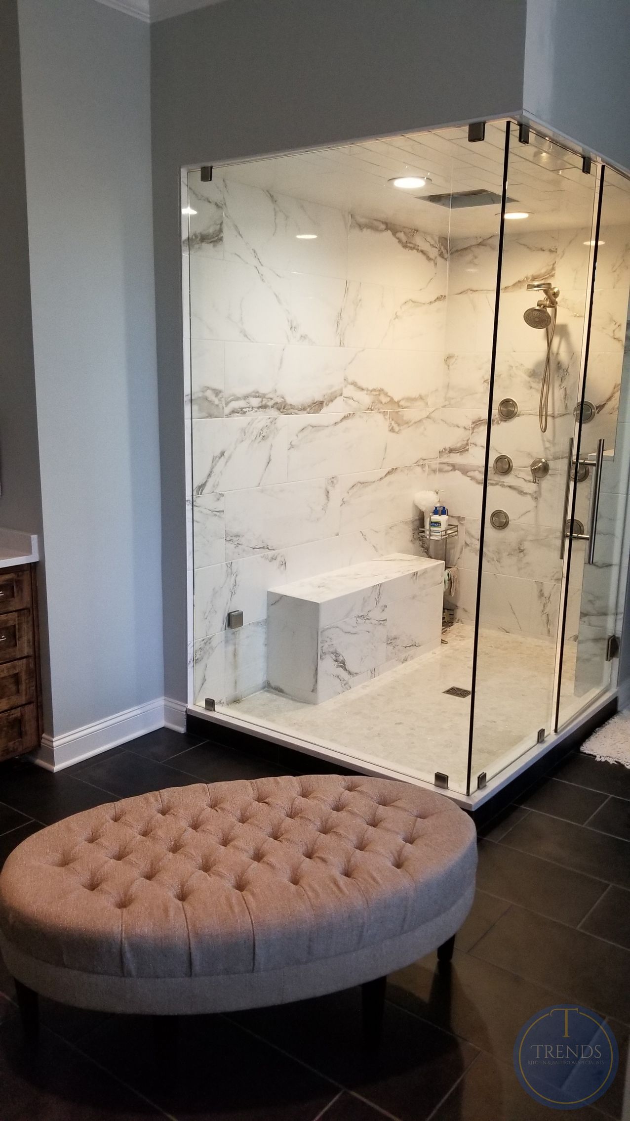 A bathroom with a bathtub and a chandelier hanging from the ceiling.