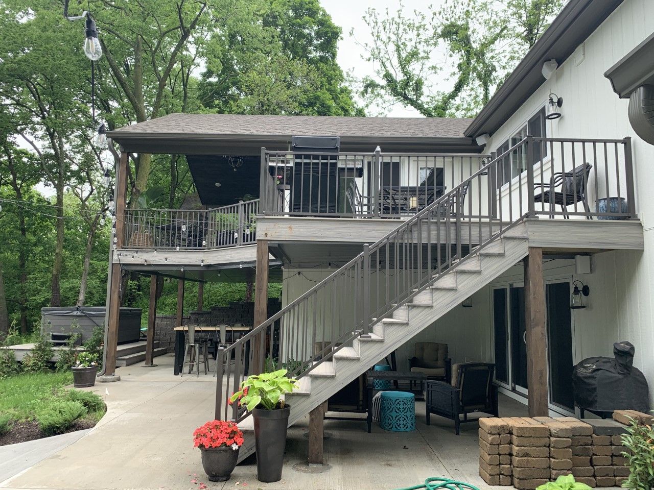 A house with a large deck and stairs leading up to it.