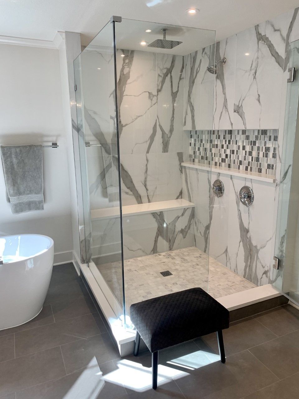 A bathroom with a walk in shower and a bathtub