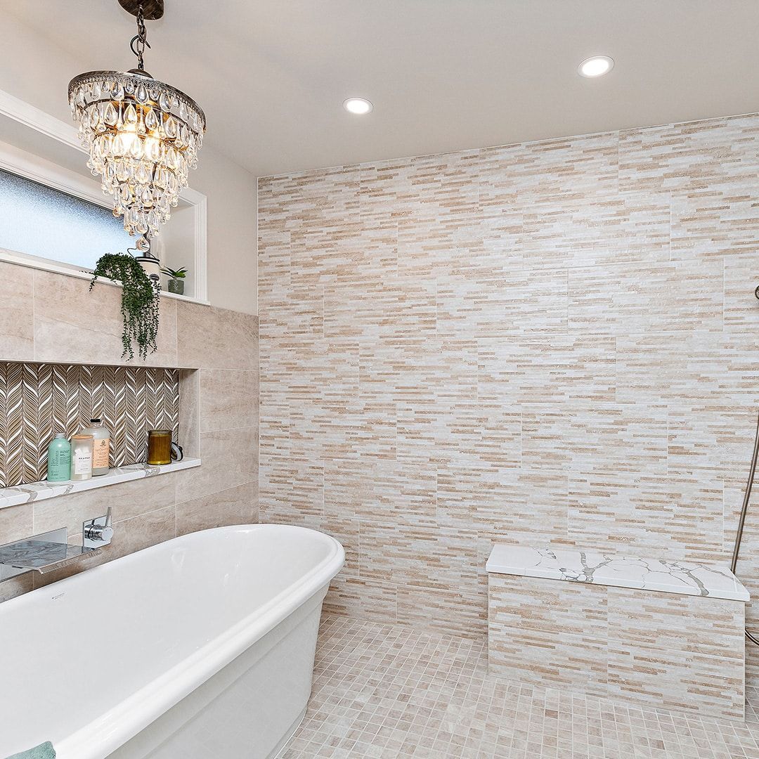 A bathroom with a bathtub and a chandelier hanging from the ceiling.