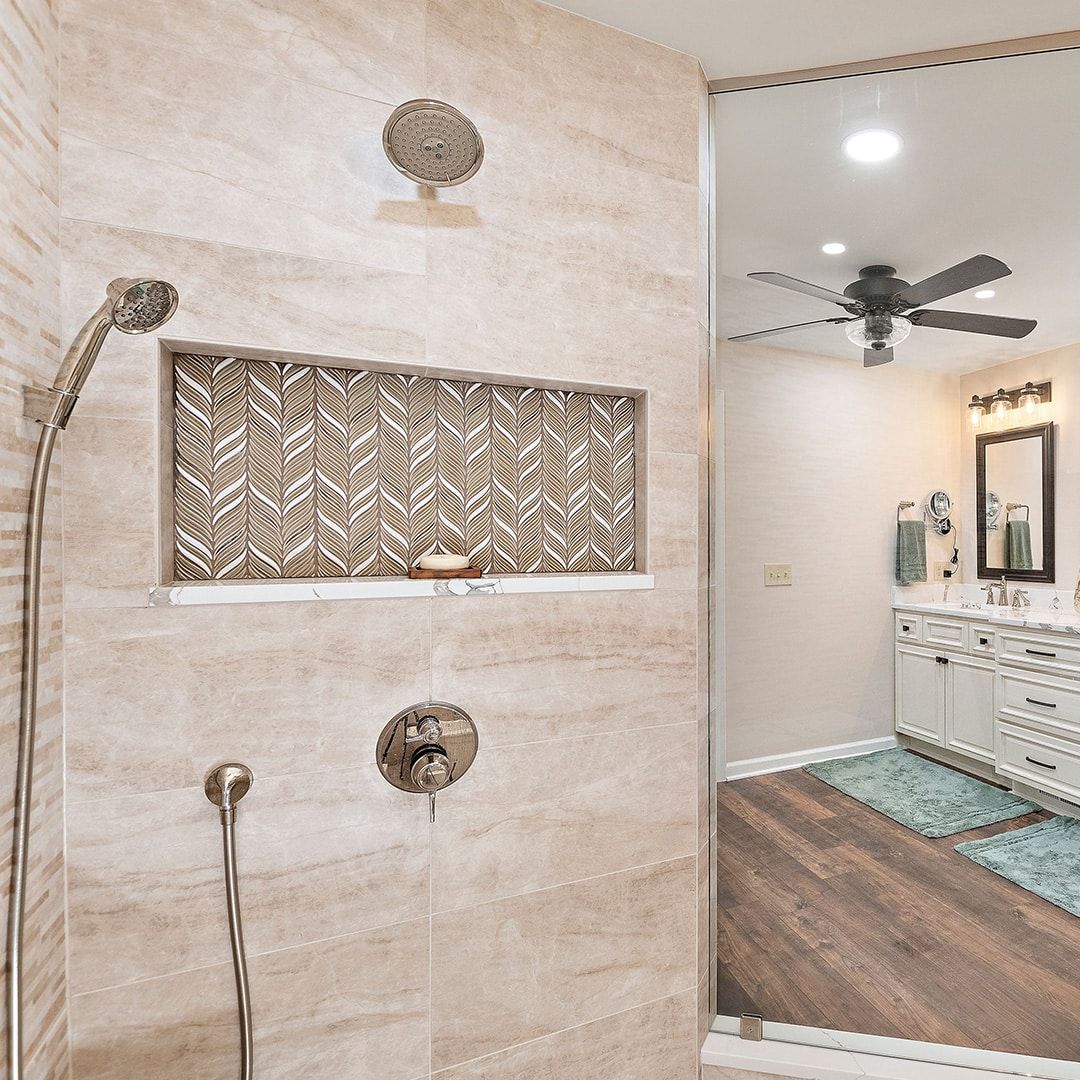 A bathroom with a walk in shower and a large mirror.