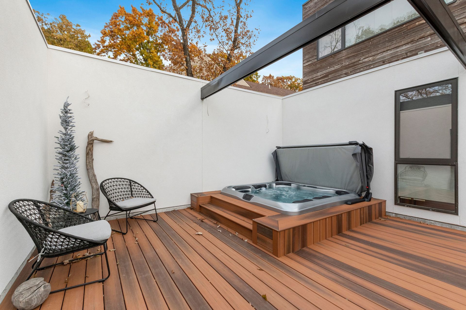 A hot tub is sitting on top of a wooden deck.