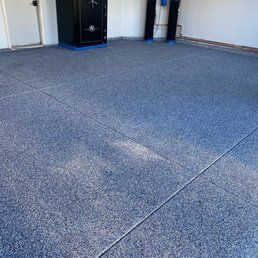 Blue speckled garage floor with a safe in the corner.