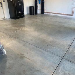 Garage with concrete floor, safe, and pipes against the wall.
