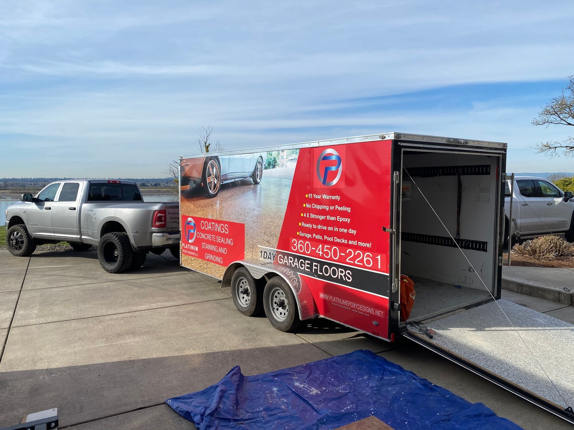 Silver truck towing a trailer with 