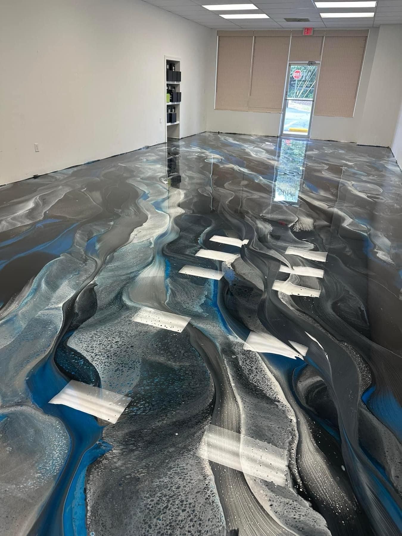 Person wearing gloves installing wooden flooring, using a hammer and mallet.