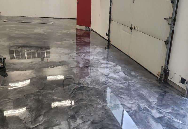 Metallic gray epoxy floor with darker mottled patterns.