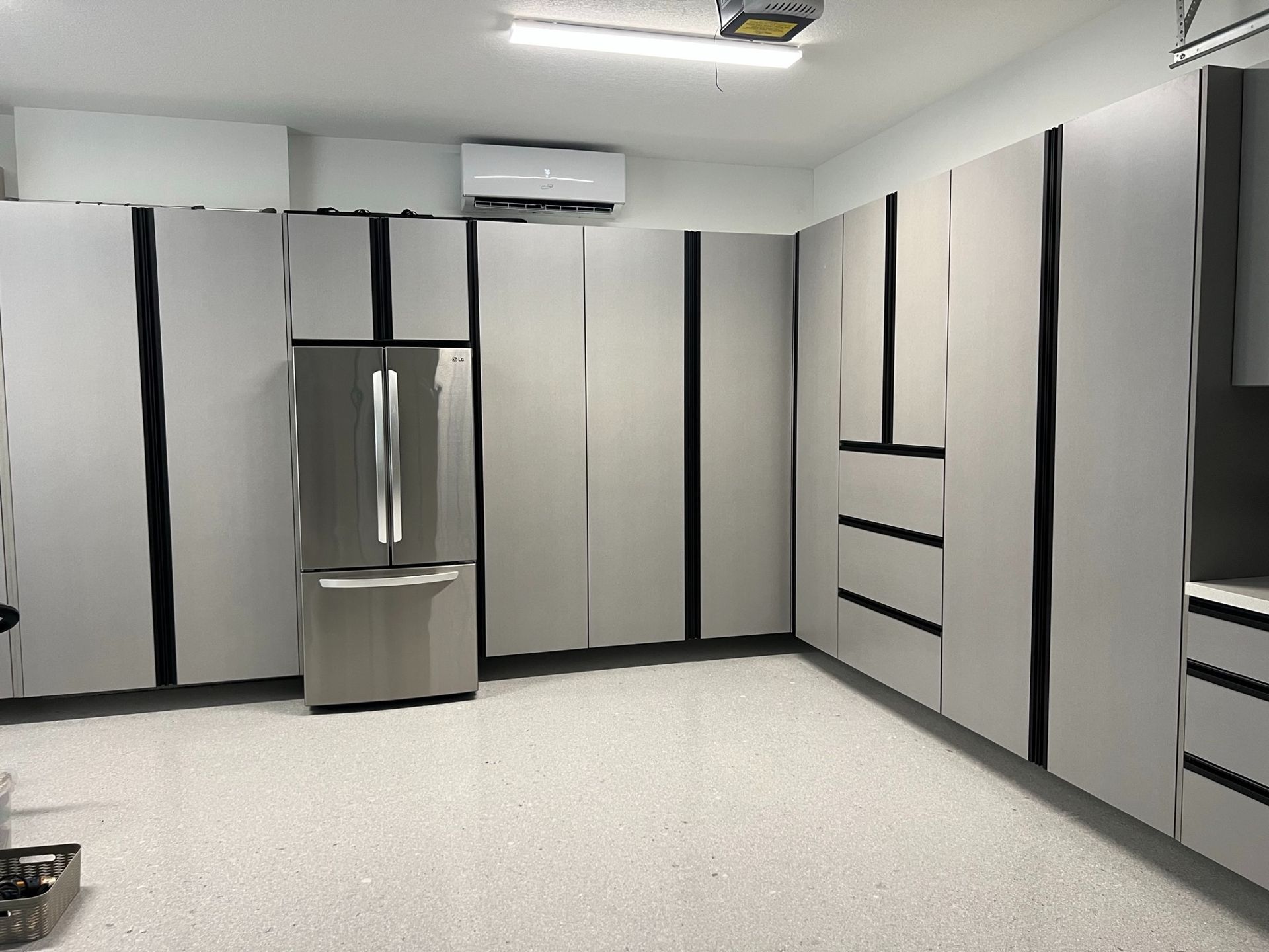 Outdoor patio with a bar, fireplace, and seating; a bi-fold door opens to an indoor space with a bar.