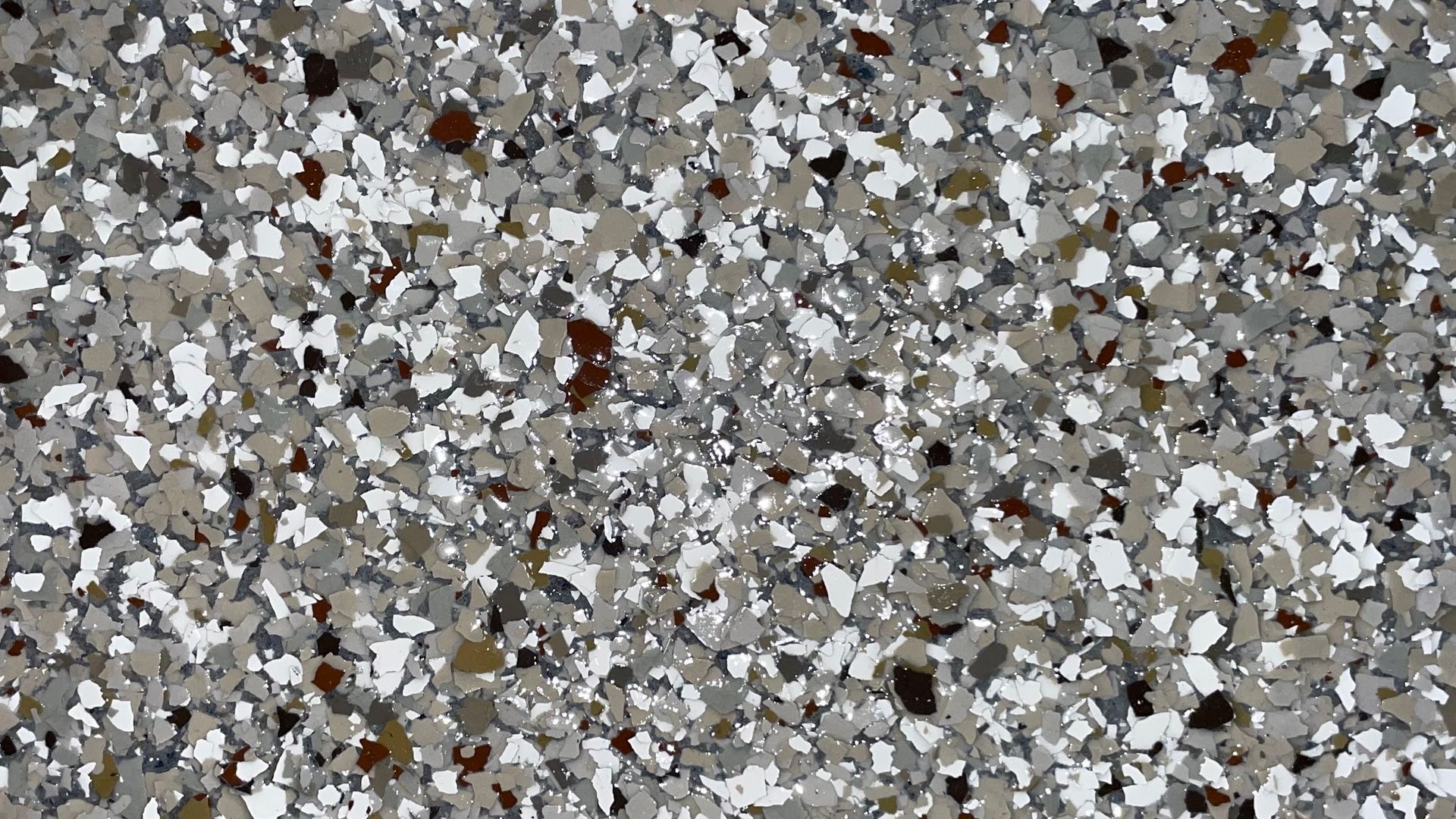 Speckled floor coating in shades of gray, white, and brown.