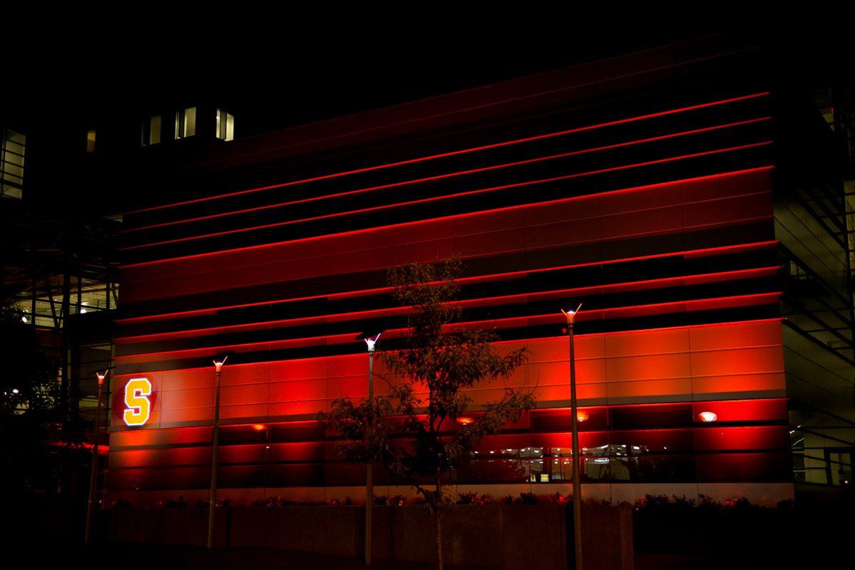Red-lit building at night with the number 
