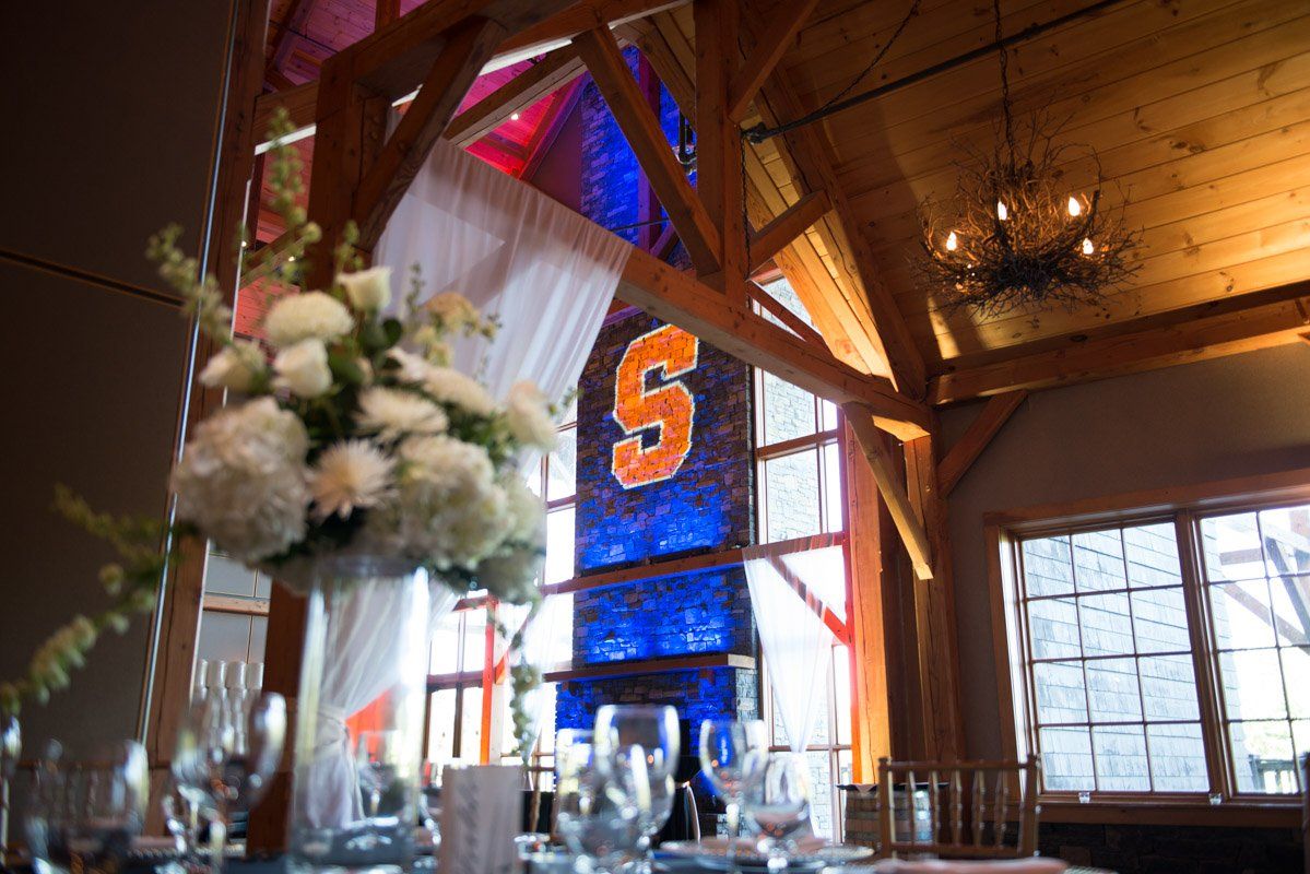 Wedding reception with white floral centerpiece and Syracuse 