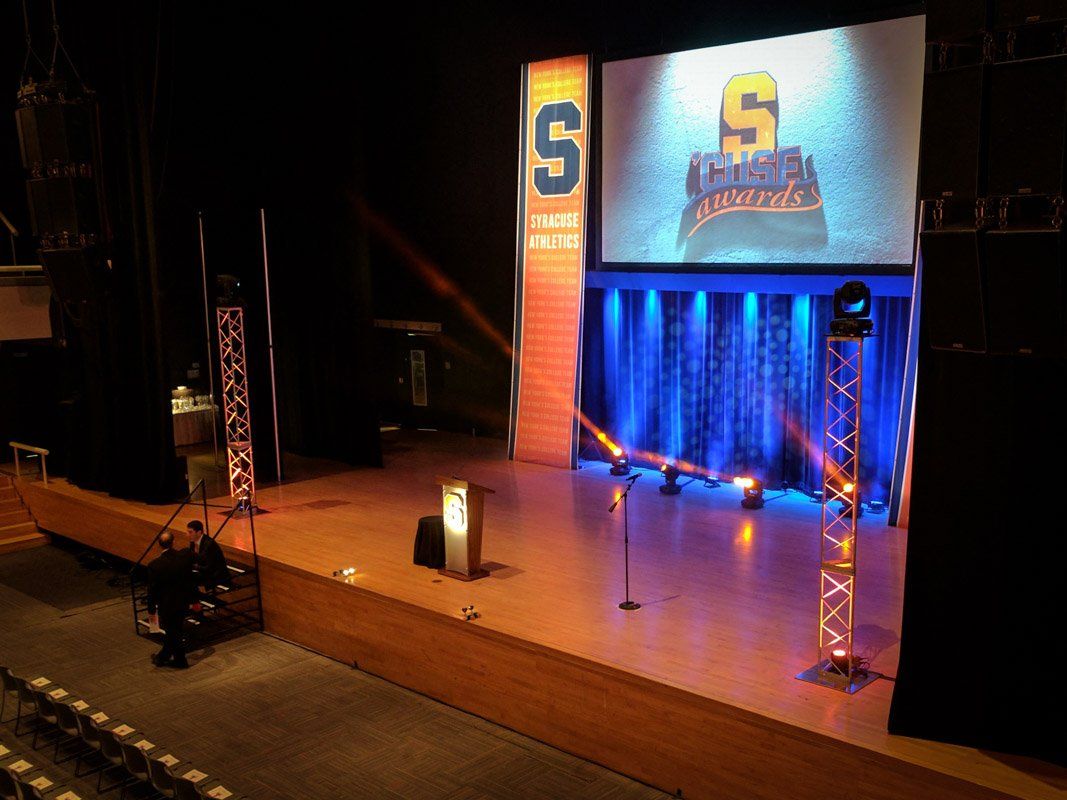 Stage setup with a large screen displaying 