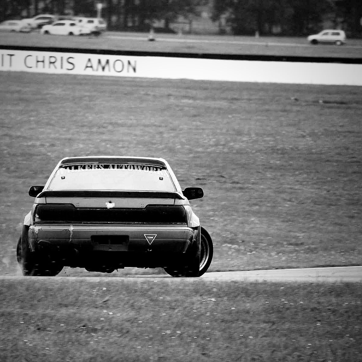 A black and white photo of CamGoDrift on a race track.