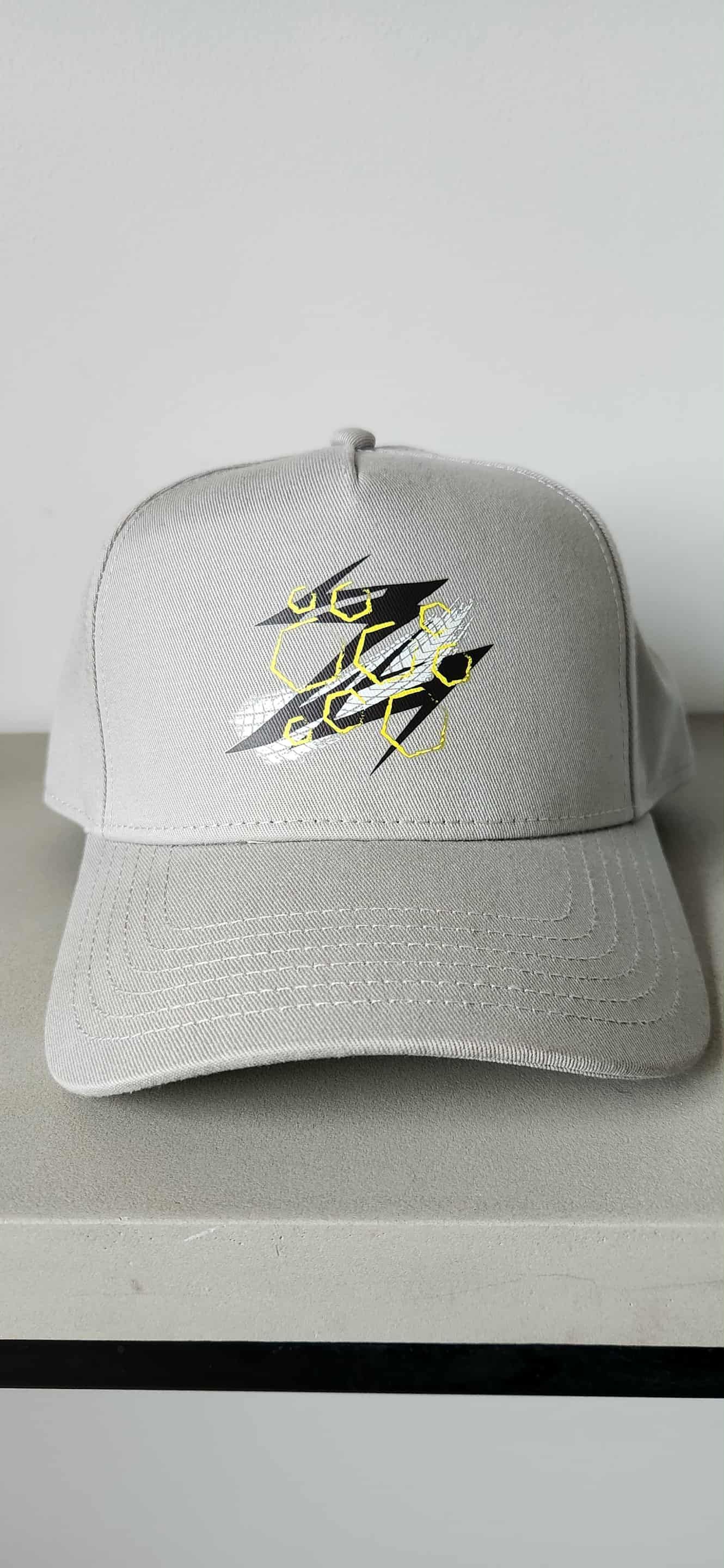 Silver sequined baseball cap with a black and yellow logo.