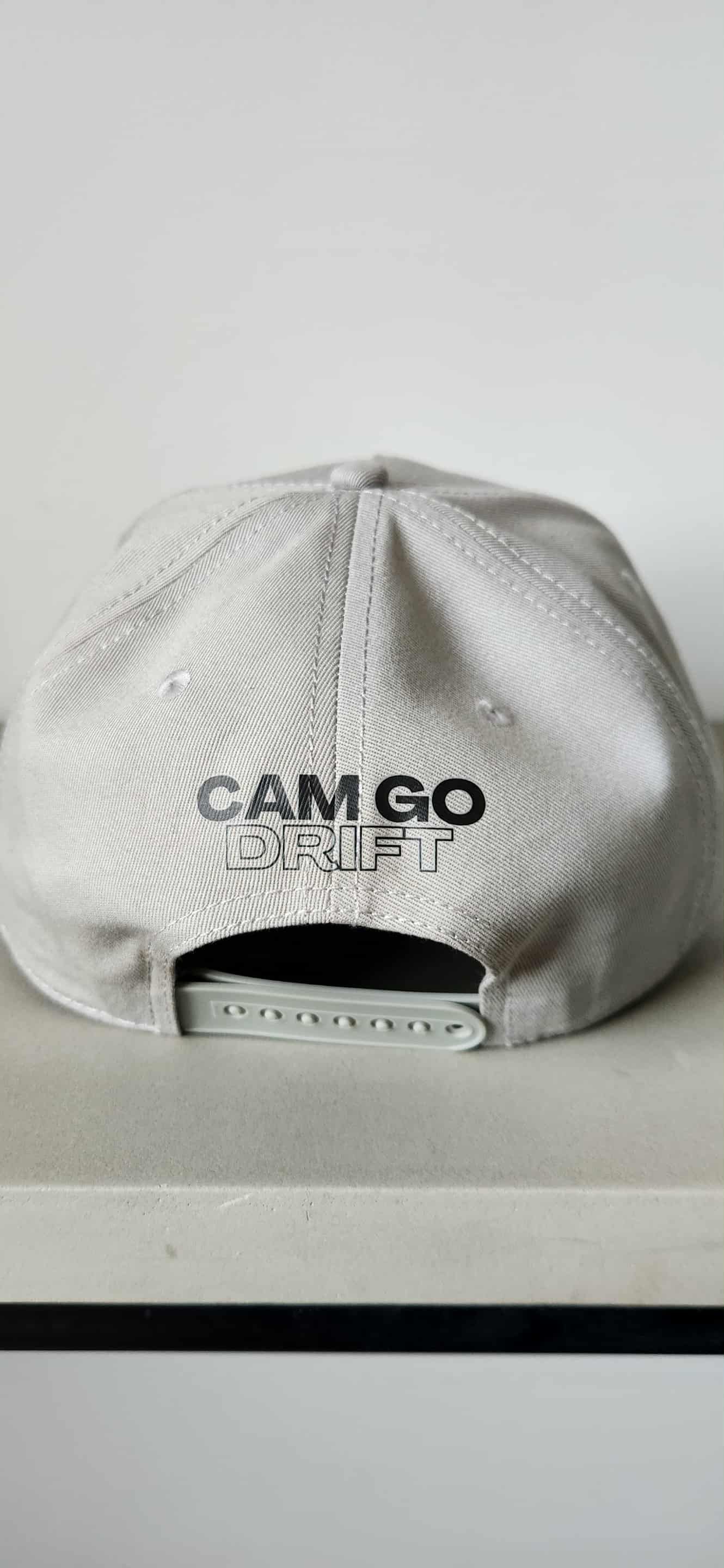 Silver sequined baseball cap with a black and yellow logo.