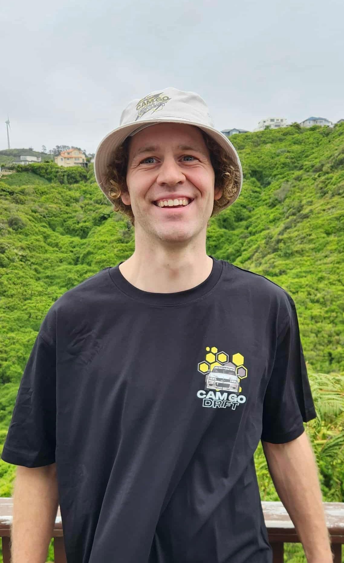 Cam wearing a CamGoDrift branded bucket hat and black t-shirt.