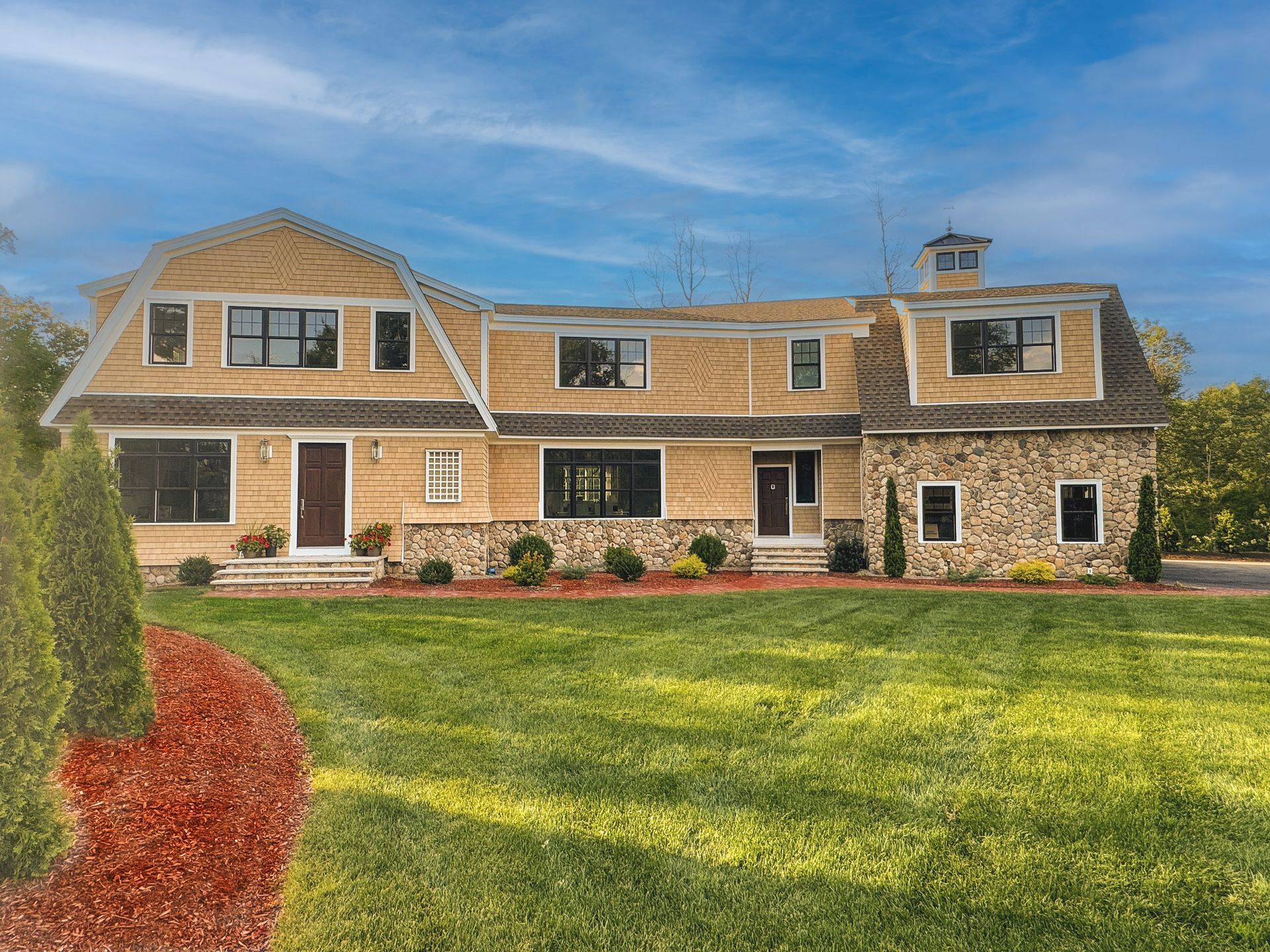 A large house with a large lawn in front of it
