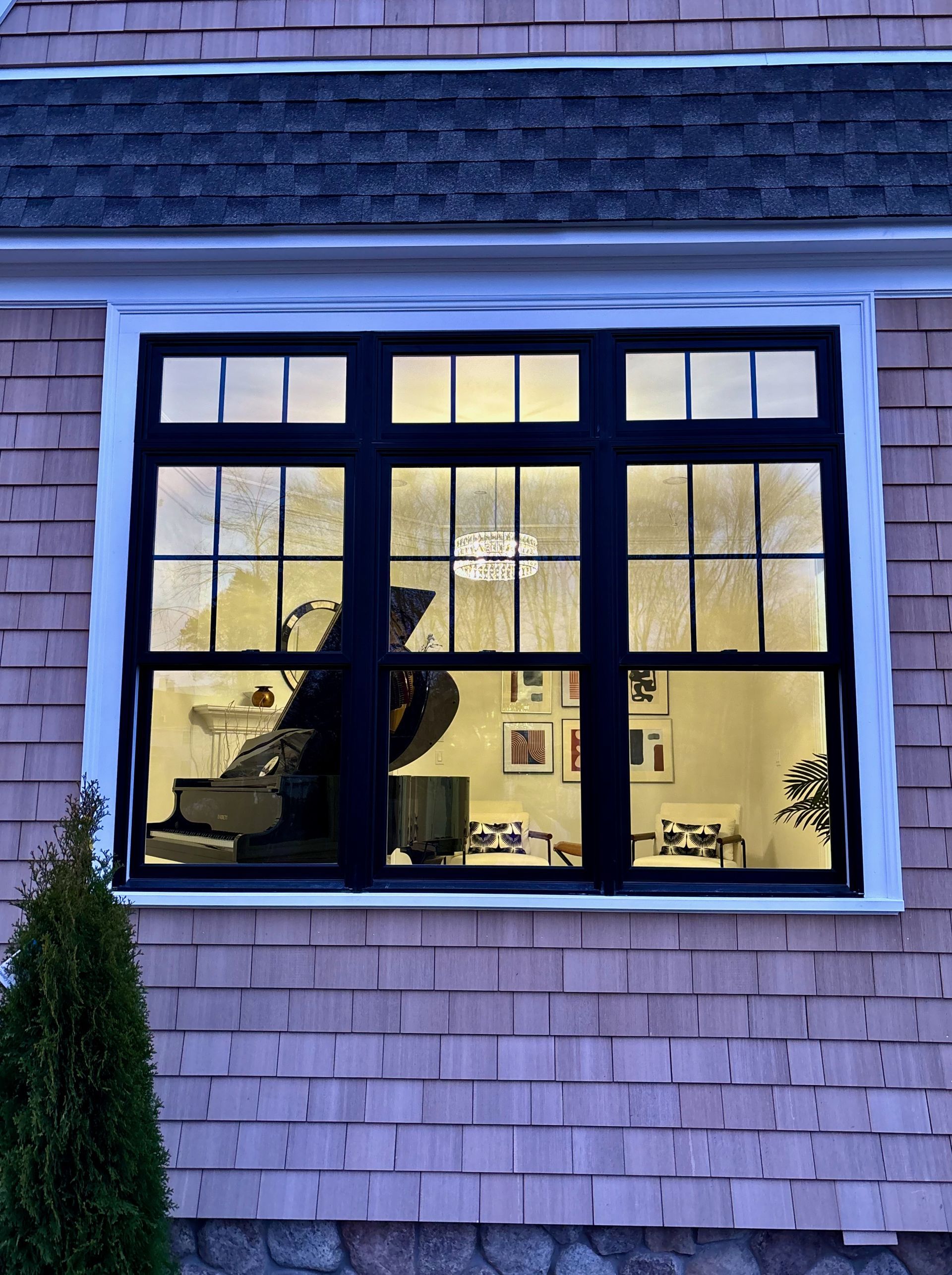 A window on the side of a house looking into a living room