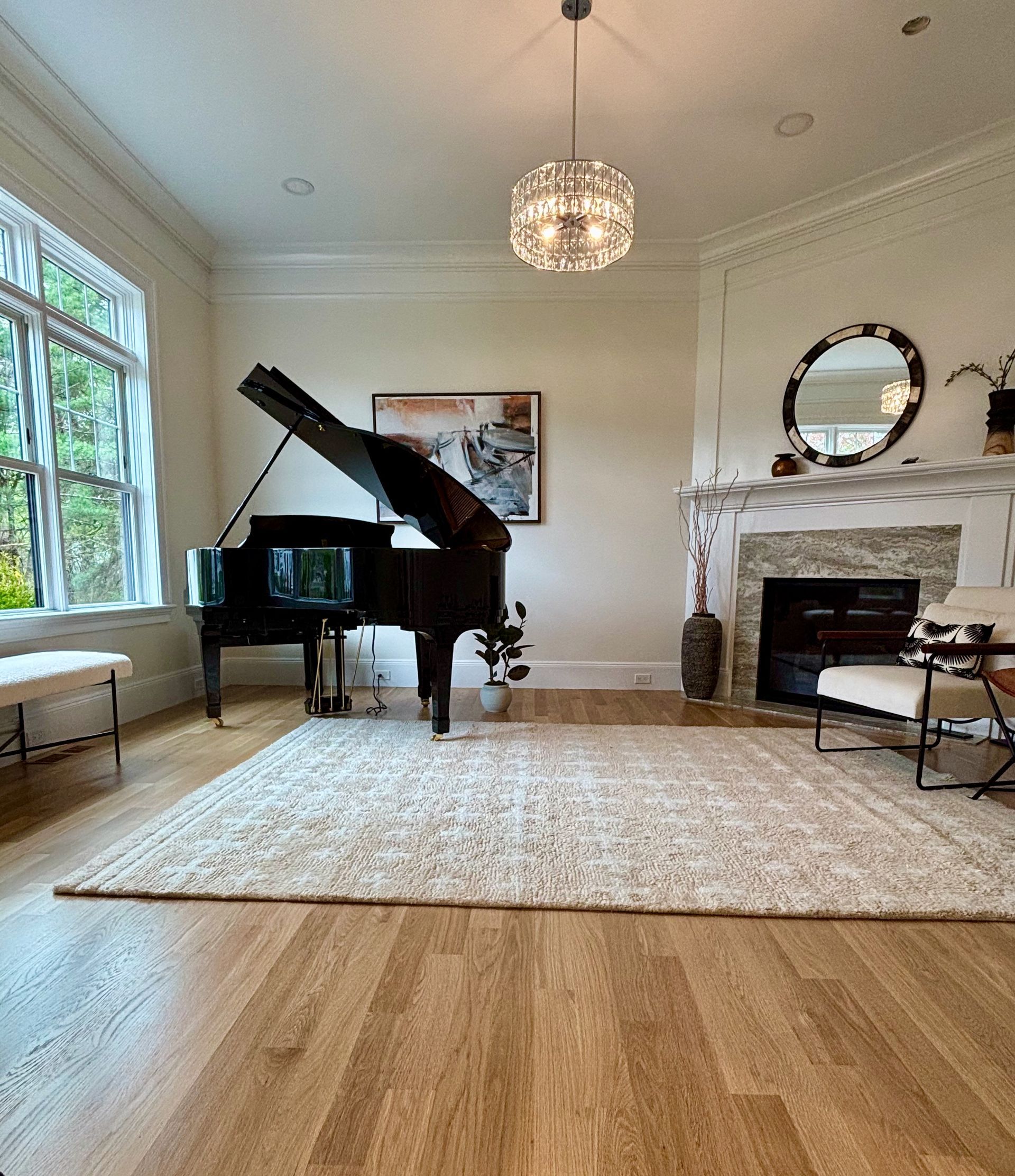 A living room with a piano and a fireplace