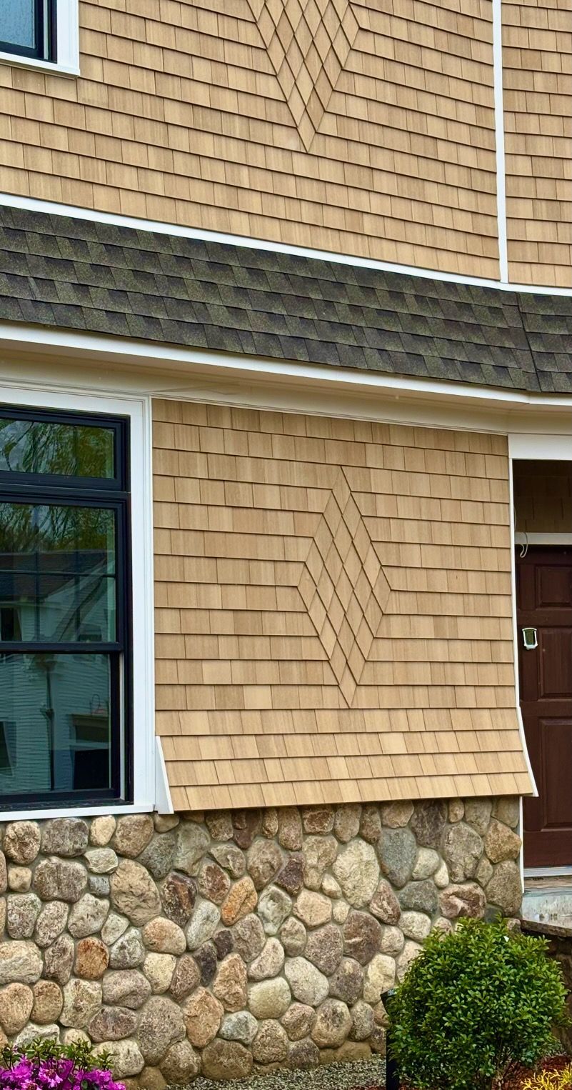 A house with a stone wall and a wooden roof.