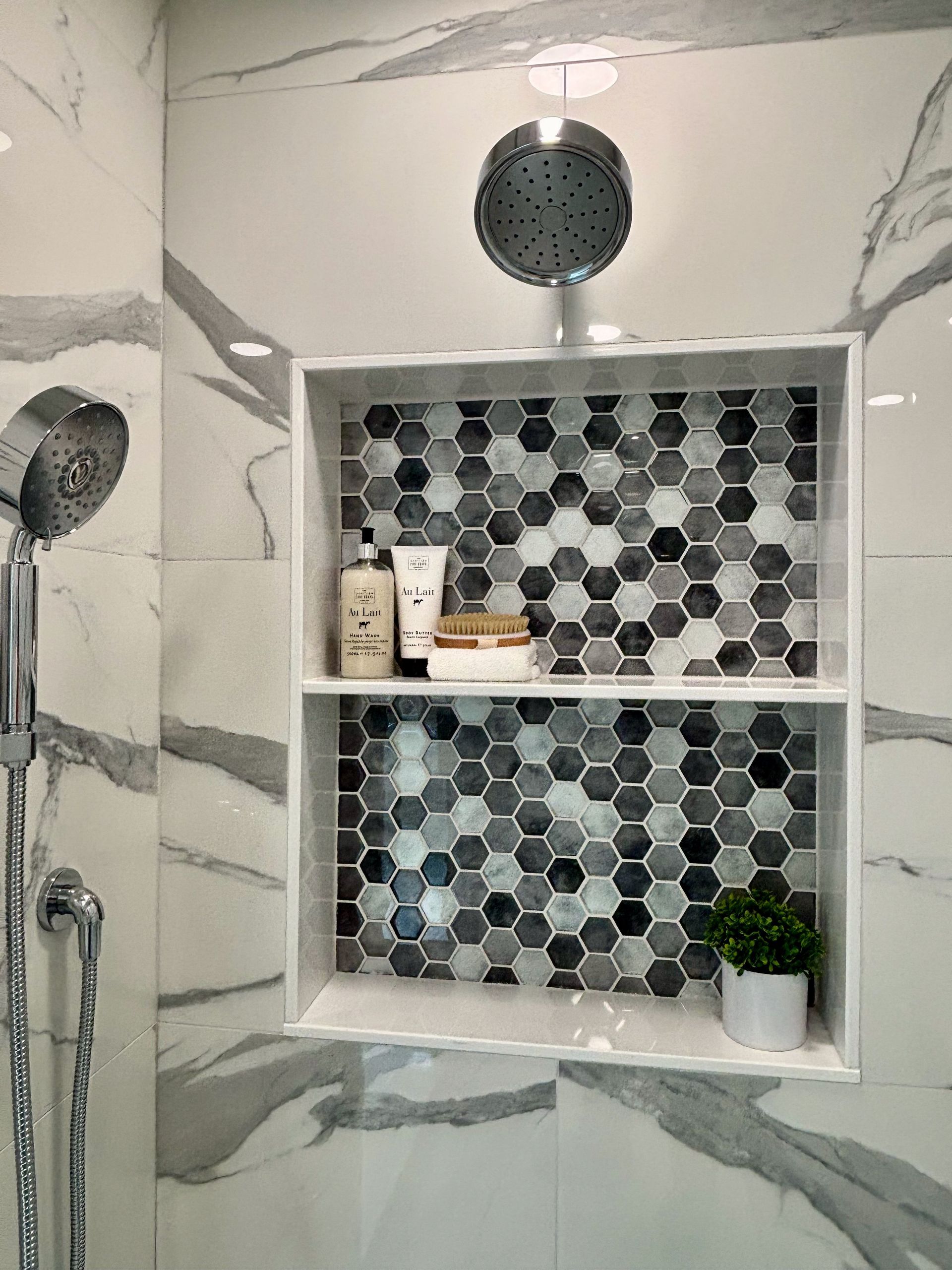 A shower with a shelf and a shower head