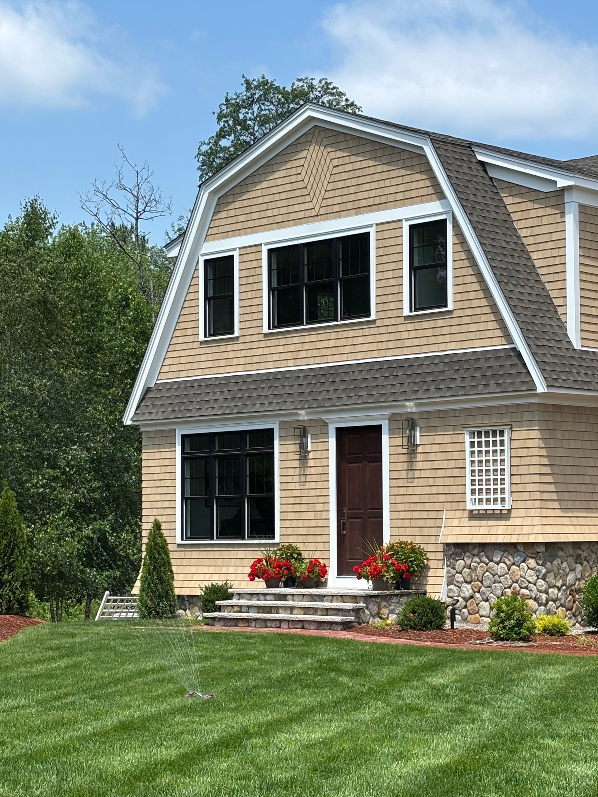 A large house with a large lawn in front of it.