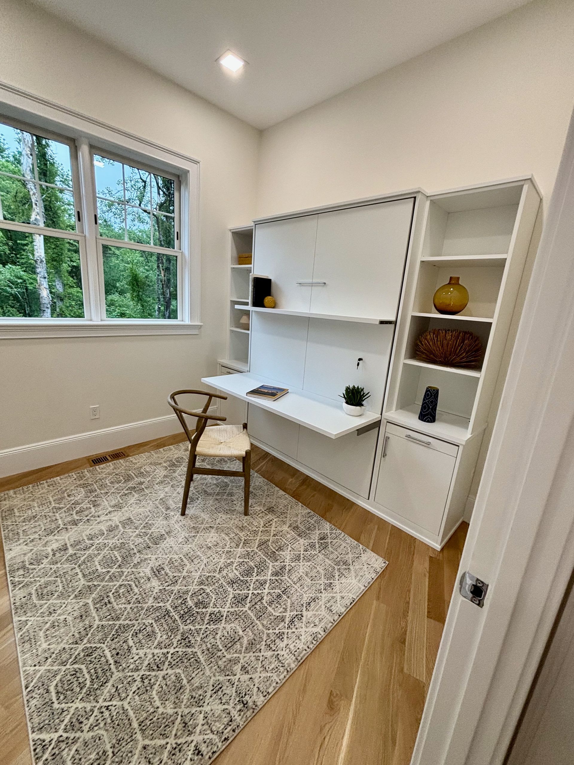 A room with a desk and a chair in it.
