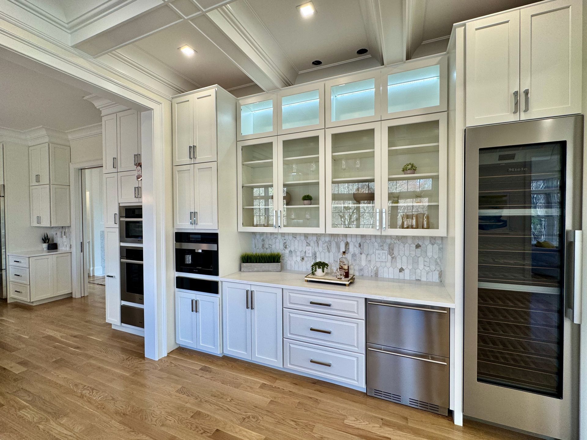 A kitchen with white cabinets and stainless steel appliances.