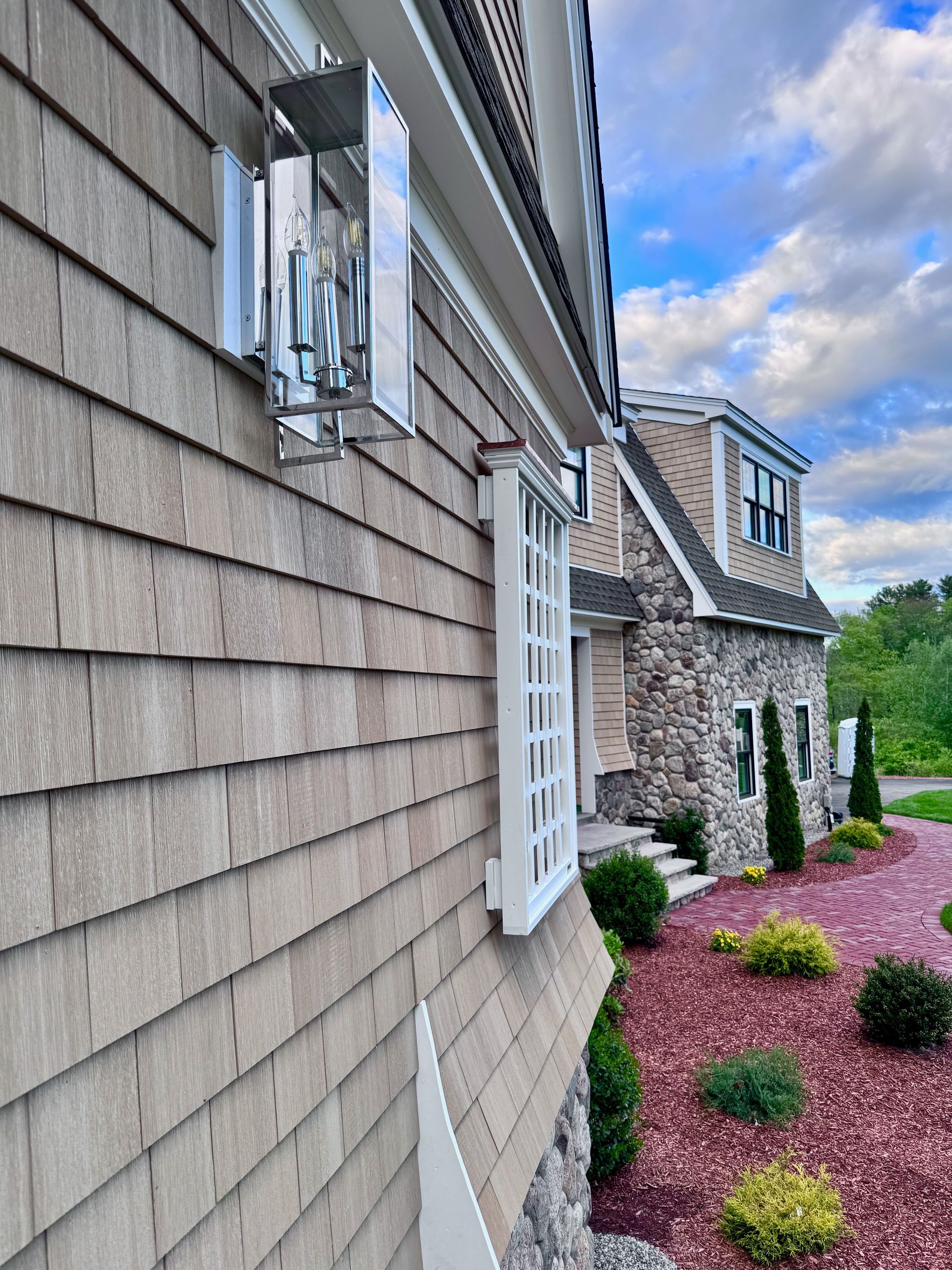 A large house with a lot of windows on the side of it.