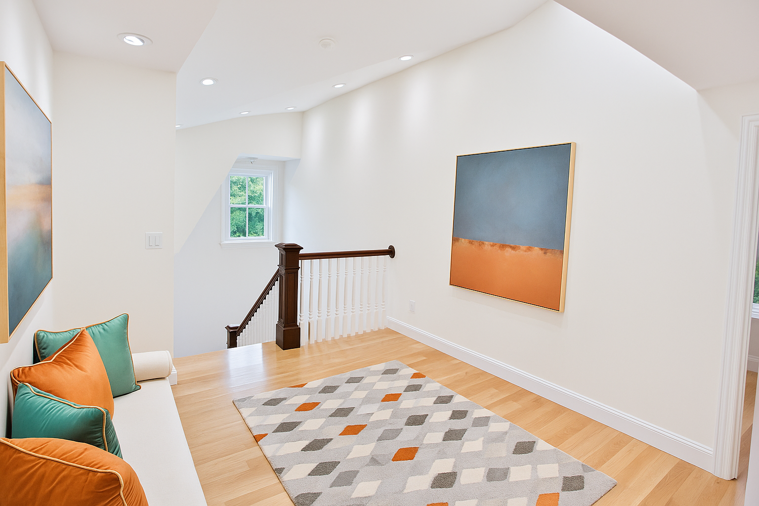 A view of a living room from the top of a staircase.