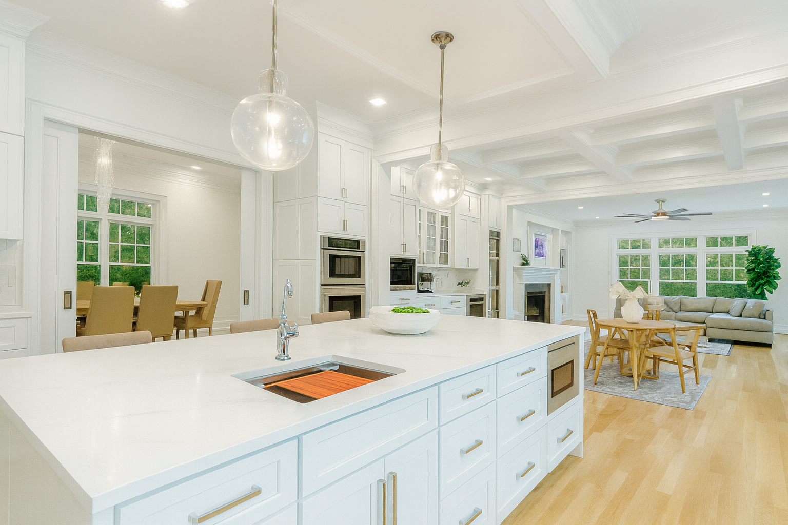A kitchen with white cabinets and a large island in the middle.