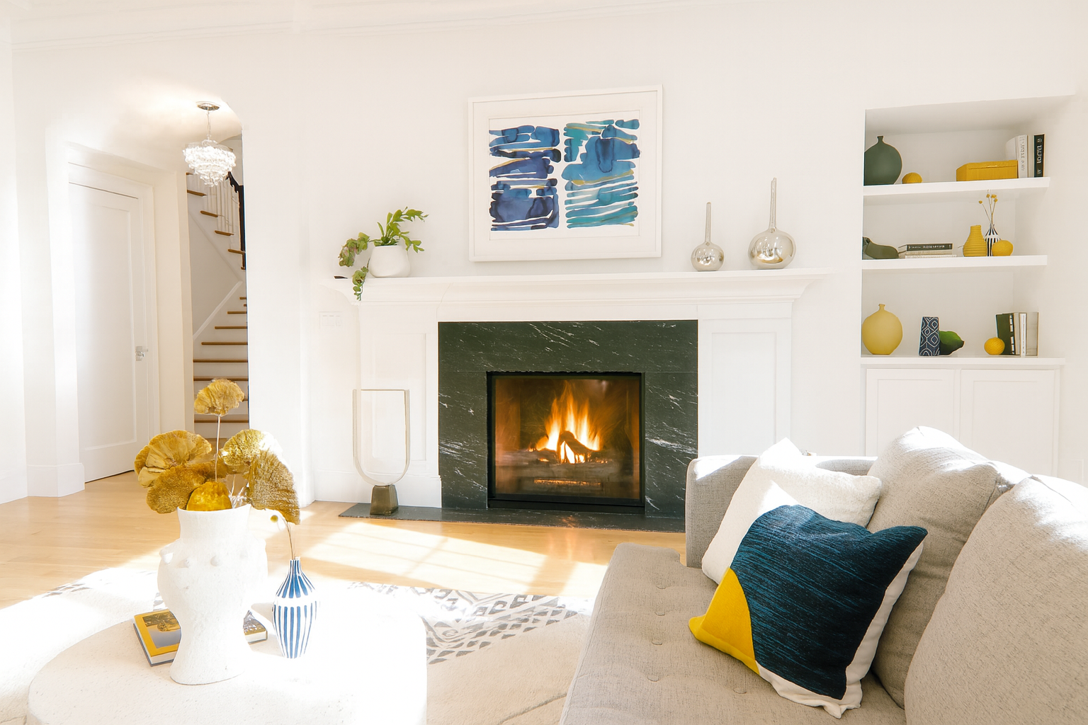 A kitchen with a large island and stools and a vase of flowers on the counter.