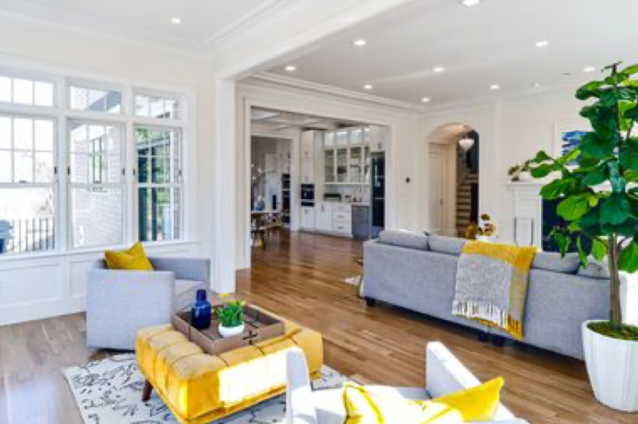 A living room with a couch , chairs , and ottoman.