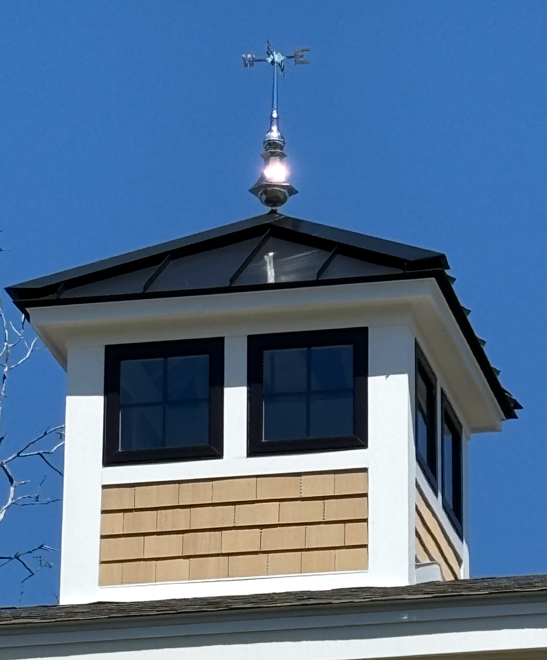 A building with a weather vane on top of it