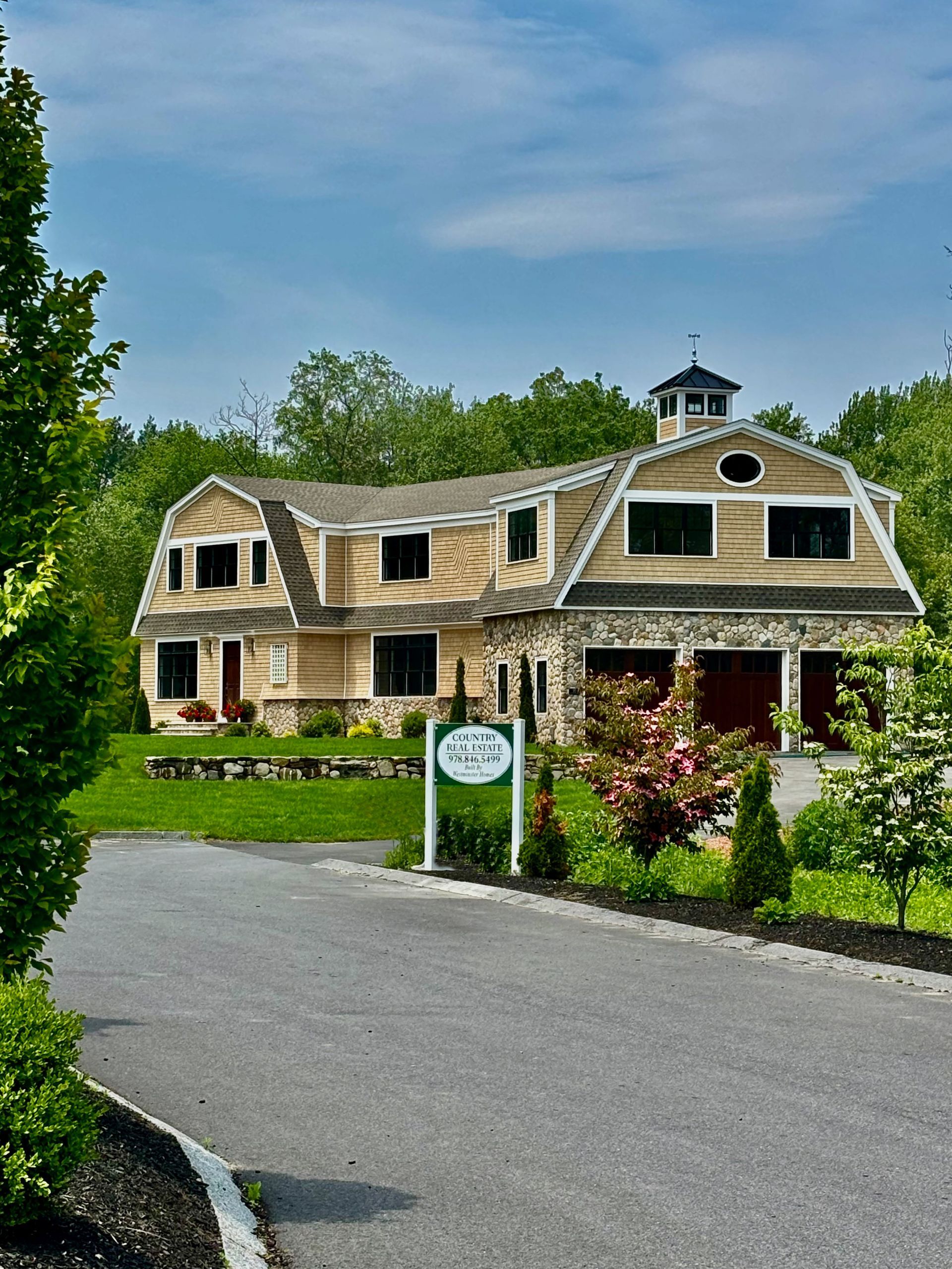 A large house with a sign in front of it.